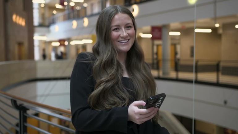 Master of Accountancy student Lauren Rishovd with cellphone