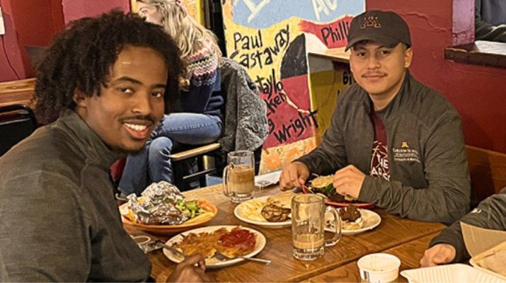 Three students with full plates of food at Hard Times Cafe.